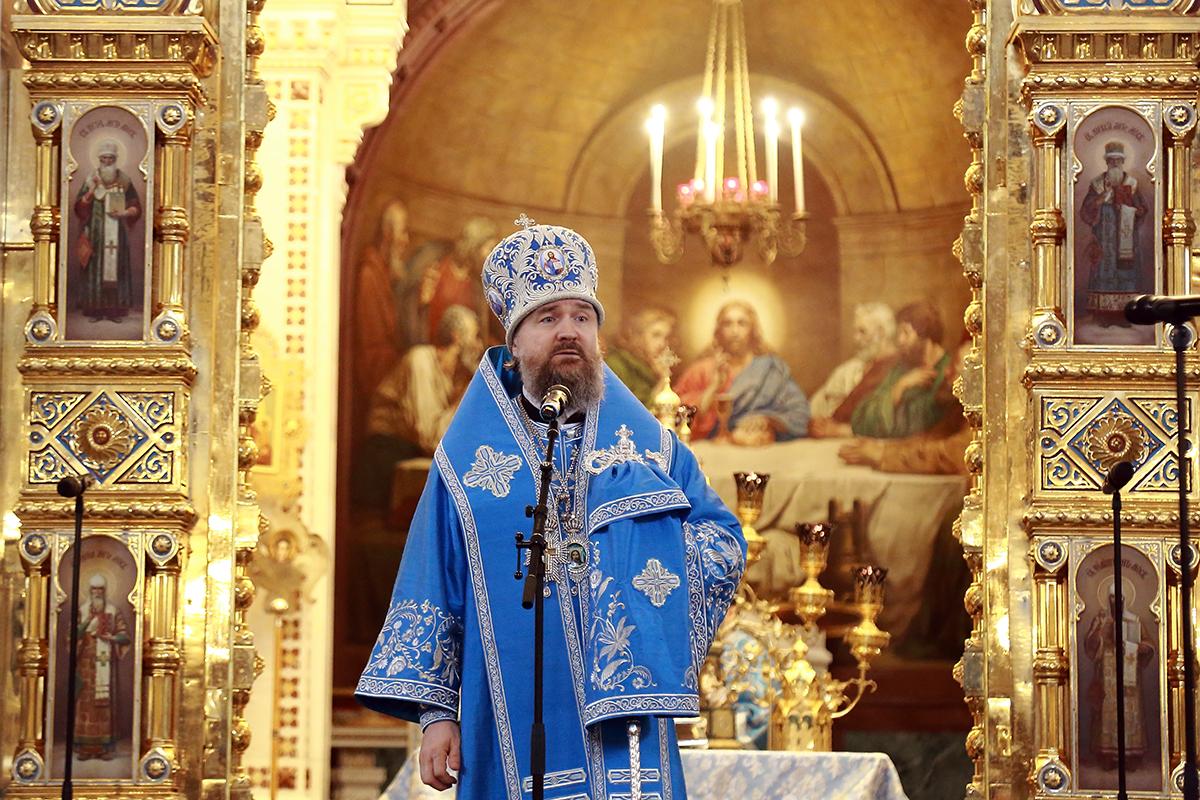 “Russian Orthodox priests carrying sacred icon during public procession”